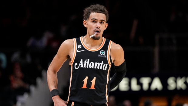 Trae Young stands at foul line during a game.